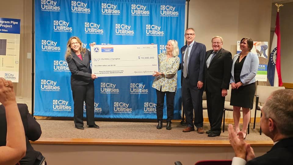 From left, Linda Daugherty of the PHMSA's Office of Pipeline Safety poses during a ceremonial check presentation with Board of Public Utilities Chair Nancy Williams, CU CEO Gary Gibson, Mayor Ken McClure and American Public Gas Association's Renee Lani.